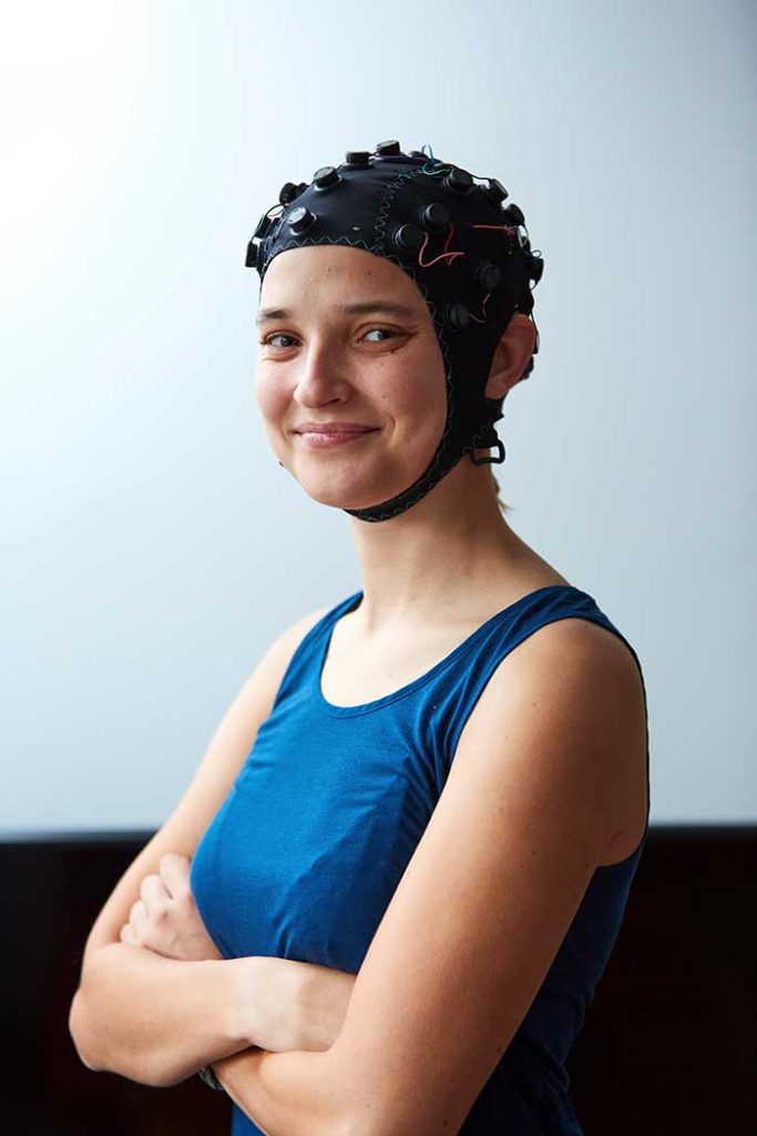 Woman wearing an EMOTIV's EPOC Flex cap.